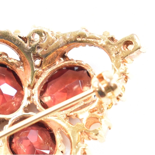 431 - Hallmarked 9ct gold garnet and pearl brooch pin. The brooch set with three oval cut garnet having ac... 