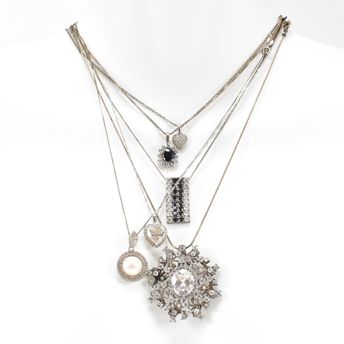 432 - A collection of silver and gem set pendant necklaces. The necklaces strung with CZ, pearl including ... 