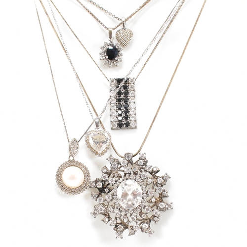 432 - A collection of silver and gem set pendant necklaces. The necklaces strung with CZ, pearl including ... 