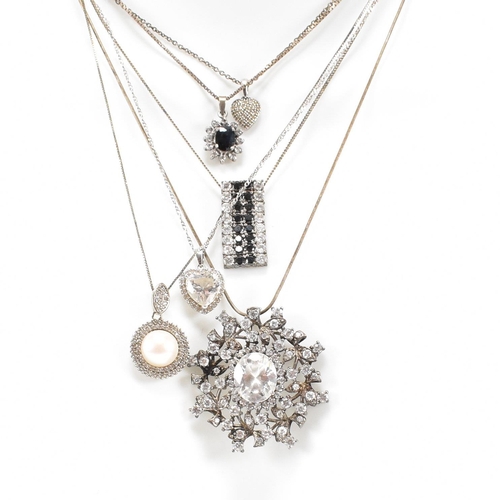 432 - A collection of silver and gem set pendant necklaces. The necklaces strung with CZ, pearl including ... 