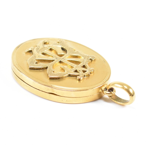 44 - A 19th century silver gilt metal monogrammed oval locket. The locket having monogram to front and in... 