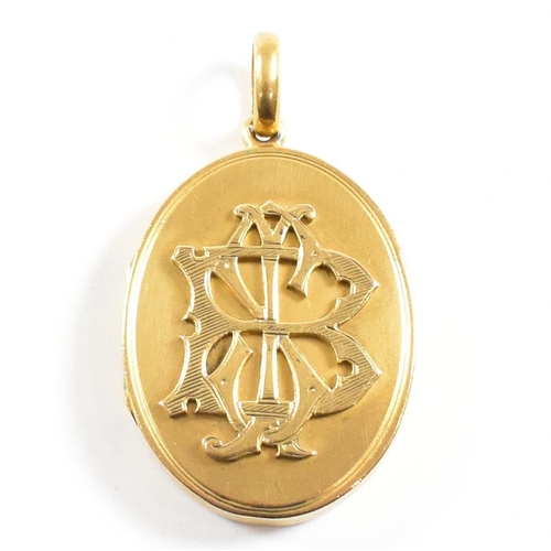 44 - A 19th century silver gilt metal monogrammed oval locket. The locket having monogram to front and in... 