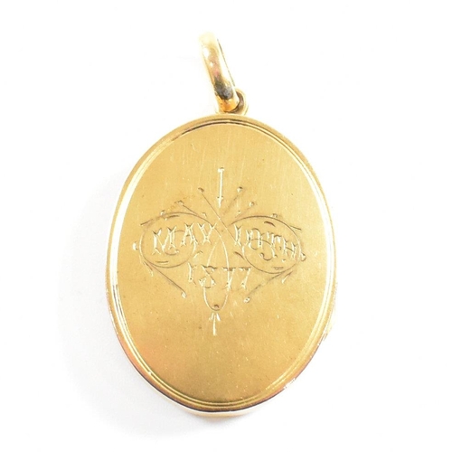 44 - A 19th century silver gilt metal monogrammed oval locket. The locket having monogram to front and in... 