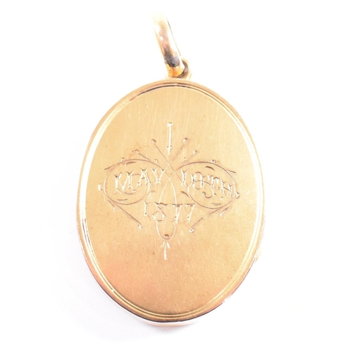 44 - A 19th century silver gilt metal monogrammed oval locket. The locket having monogram to front and in... 