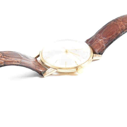 446 - A hallmarked 1960s 9ct gold Cyma gentleman's wrist watch. The watch having champagne dial with baton... 