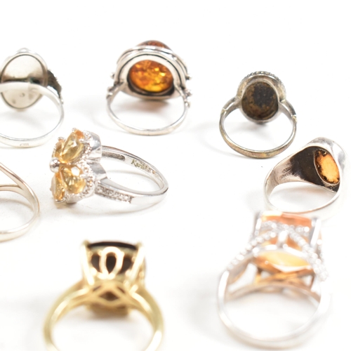 449 - A collection of 925 silver and gem set rings. The rings to include citrine, smoky quartz, amber, CZ,... 