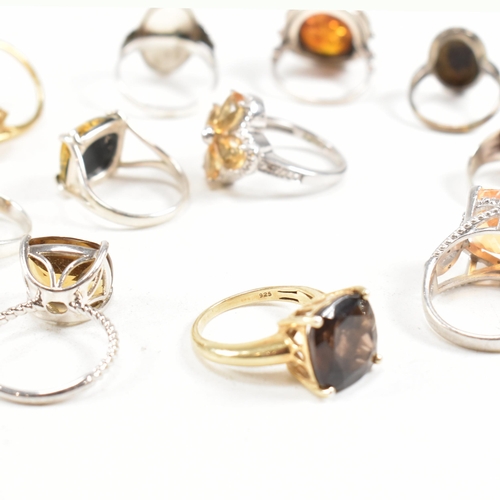 449 - A collection of 925 silver and gem set rings. The rings to include citrine, smoky quartz, amber, CZ,... 