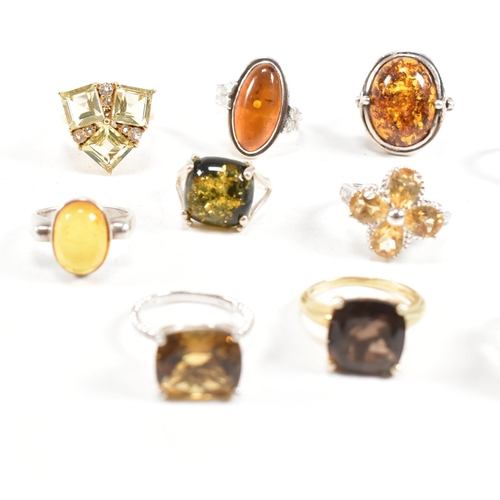 449 - A collection of 925 silver and gem set rings. The rings to include citrine, smoky quartz, amber, CZ,... 