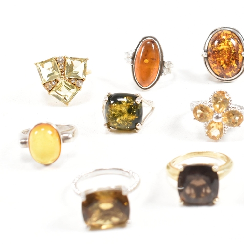 449 - A collection of 925 silver and gem set rings. The rings to include citrine, smoky quartz, amber, CZ,... 