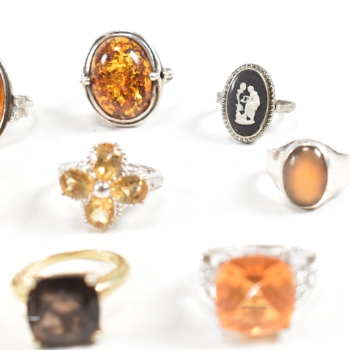 449 - A collection of 925 silver and gem set rings. The rings to include citrine, smoky quartz, amber, CZ,... 