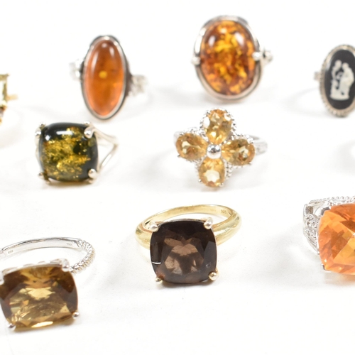 449 - A collection of 925 silver and gem set rings. The rings to include citrine, smoky quartz, amber, CZ,... 