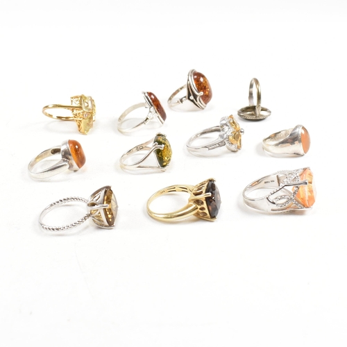 449 - A collection of 925 silver and gem set rings. The rings to include citrine, smoky quartz, amber, CZ,... 