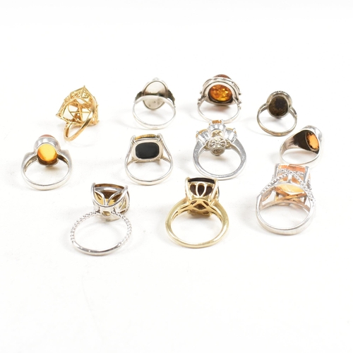 449 - A collection of 925 silver and gem set rings. The rings to include citrine, smoky quartz, amber, CZ,... 