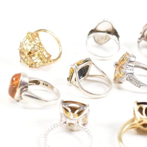 449 - A collection of 925 silver and gem set rings. The rings to include citrine, smoky quartz, amber, CZ,... 