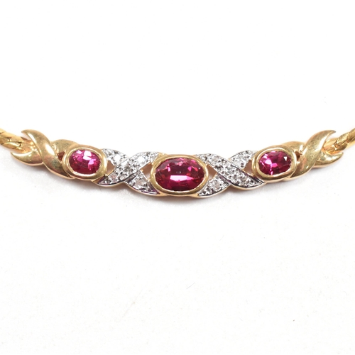 45 - A hallmarked 9ct gold synthetic ruby and diamond pendant necklace. Weight 6.4g. Measures 43cm. Cased... 