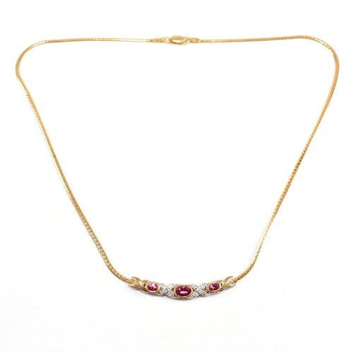 45 - A hallmarked 9ct gold synthetic ruby and diamond pendant necklace. Weight 6.4g. Measures 43cm. Cased... 