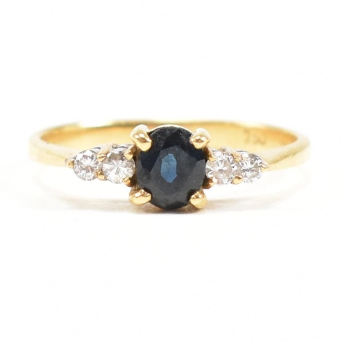 452 - A gold sapphire and diamond five stone ring. The ring set with a central sapphire flanked by four di... 