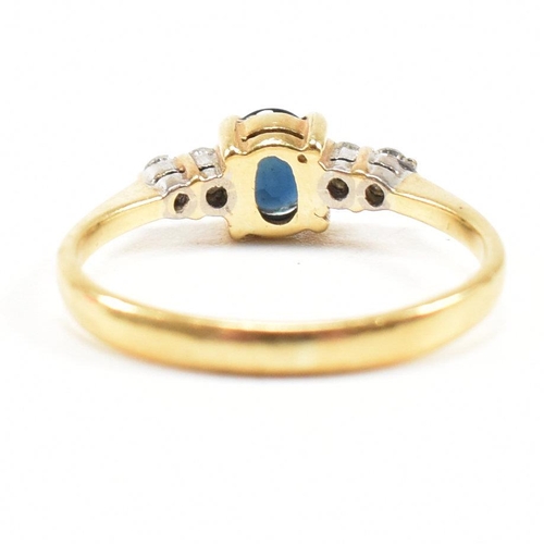 452 - A gold sapphire and diamond five stone ring. The ring set with a central sapphire flanked by four di... 