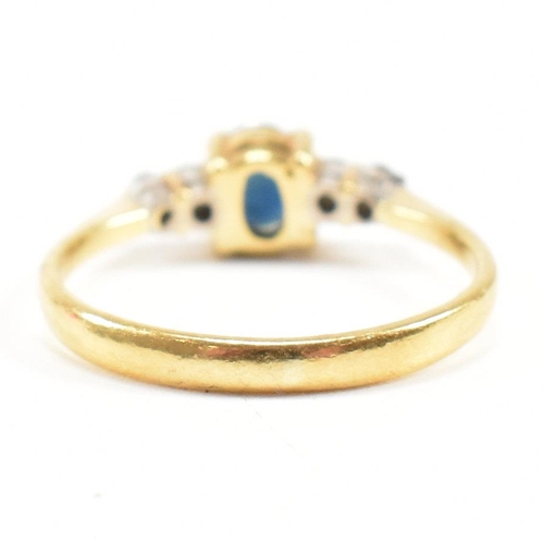 452 - A gold sapphire and diamond five stone ring. The ring set with a central sapphire flanked by four di... 