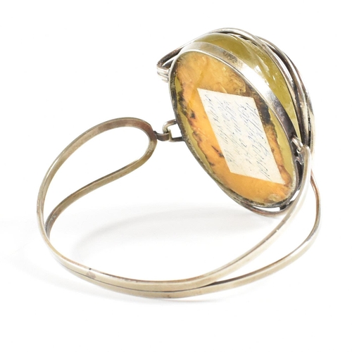 454 - A white metal and amber pendant necklace together with an amber and resin set hinged bangle and a gr... 