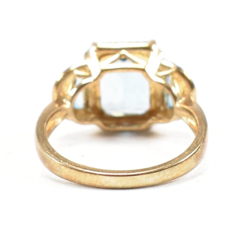 46 - A hallmarked 9ct gold topaz and diamond triple halo ring. Weight 3.9g. Size O. All weights, measurem... 