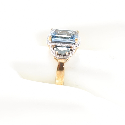 46 - A hallmarked 9ct gold topaz and diamond triple halo ring. Weight 3.9g. Size O. All weights, measurem... 