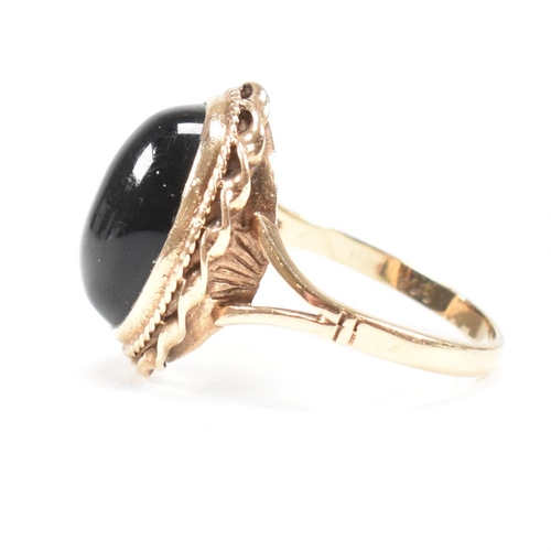 47 - A mid-century 9ct gold and onyx cabochon ring. Marked 9ct. Weight 4g. Size L.5. All weights, measure... 