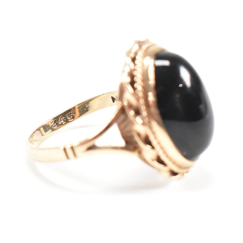 47 - A mid-century 9ct gold and onyx cabochon ring. Marked 9ct. Weight 4g. Size L.5. All weights, measure... 