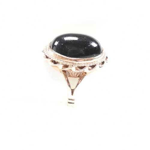 47 - A mid-century 9ct gold and onyx cabochon ring. Marked 9ct. Weight 4g. Size L.5. All weights, measure... 