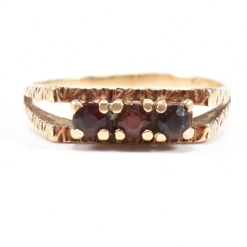 470 - A 1970s gold and garnet three stone ring. Partial marks for 9ct gold. Weight 2.4g. Size P. All weigh... 