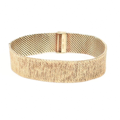 A 1970s hallmarked 9ct gold mesh bracelet. The bracelet formed with ...