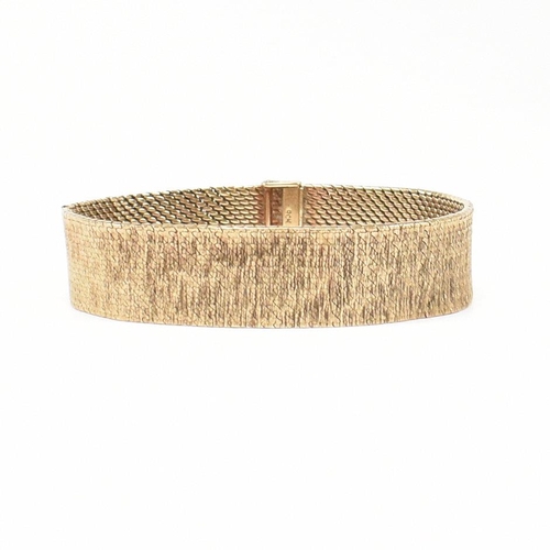 50 - A 1970s hallmarked 9ct gold mesh bracelet. The bracelet formed with textured bark style mesh links t... 