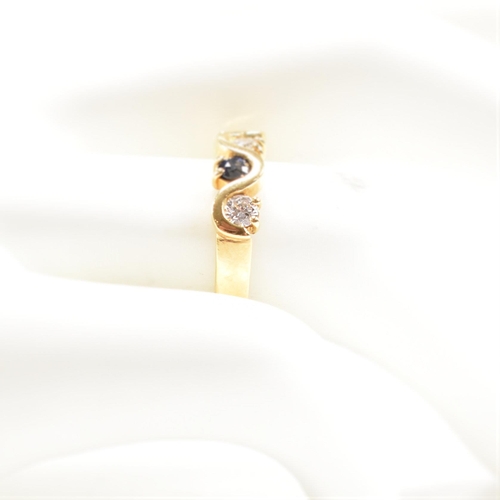 52 - A hallmarked 18ct gold sapphire and diamond five stone ring. The ring set with three round brilliant... 