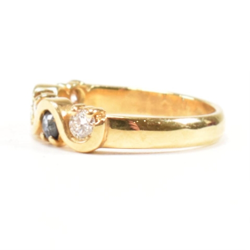 52 - A hallmarked 18ct gold sapphire and diamond five stone ring. The ring set with three round brilliant... 