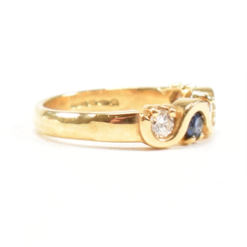 52 - A hallmarked 18ct gold sapphire and diamond five stone ring. The ring set with three round brilliant... 