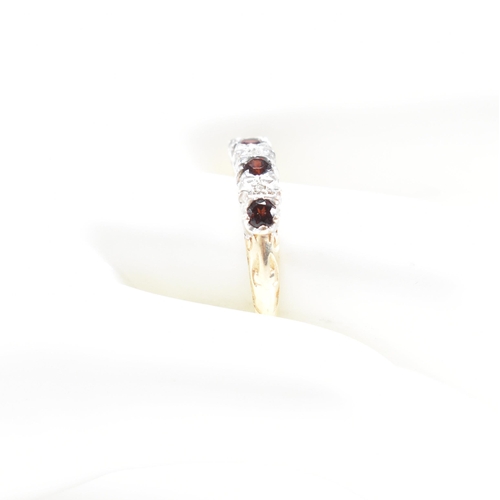 57 - A hallmarked garnet and diamond half hoop ring. Hallmarked Sheffield. Weight 2.1g. Size P.  Weights,... 