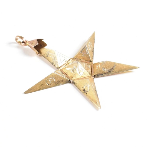 61 - A 1920s 9ct gold and silver Masonic pyramid star pendant. The pyramid opening to reveal a five point... 