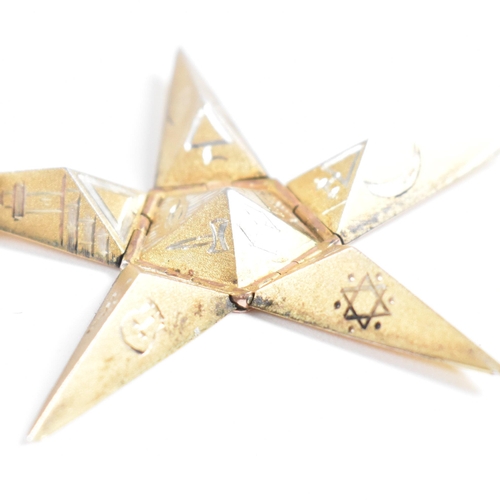 61 - A 1920s 9ct gold and silver Masonic pyramid star pendant. The pyramid opening to reveal a five point... 