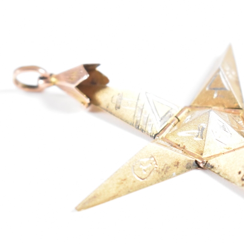 61 - A 1920s 9ct gold and silver Masonic pyramid star pendant. The pyramid opening to reveal a five point... 