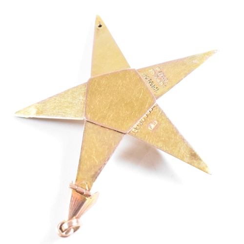 61 - A 1920s 9ct gold and silver Masonic pyramid star pendant. The pyramid opening to reveal a five point... 