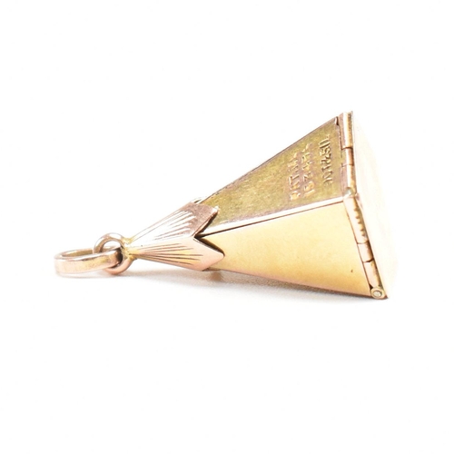 61 - A 1920s 9ct gold and silver Masonic pyramid star pendant. The pyramid opening to reveal a five point... 