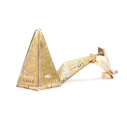 61 - A 1920s 9ct gold and silver Masonic pyramid star pendant. The pyramid opening to reveal a five point... 