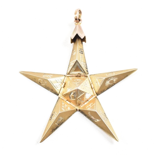 61 - A 1920s 9ct gold and silver Masonic pyramid star pendant. The pyramid opening to reveal a five point... 