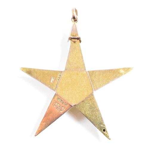 61 - A 1920s 9ct gold and silver Masonic pyramid star pendant. The pyramid opening to reveal a five point... 