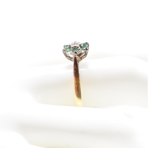 69 - A hallmarked 18ct gold emerald and diamond cluster ring. The ring hallmarked London. Weight 2.9g. Si... 