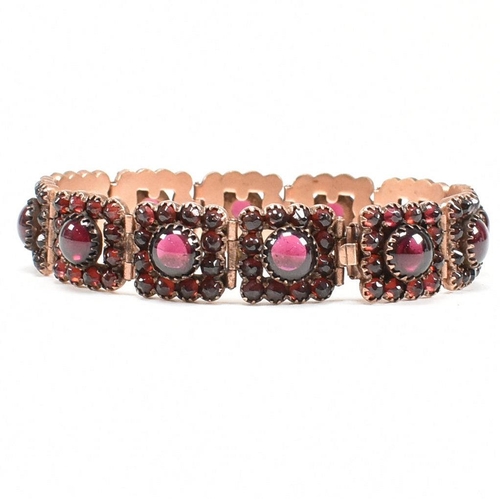 7 - A Victorian 19th century bohemian garnet gilt metal panel bracelet. The bracelet formed with 12 pane... 