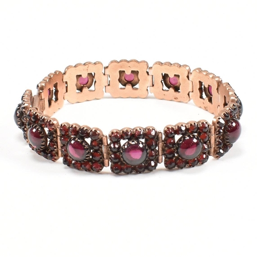 7 - A Victorian 19th century bohemian garnet gilt metal panel bracelet. The bracelet formed with 12 pane... 