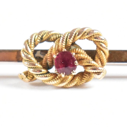 73 - A 1920s 9ct gold and ruby knot bar brooch pin. Marked 9ct. Weight 3.2g. Measures 5cm. All weights, m... 