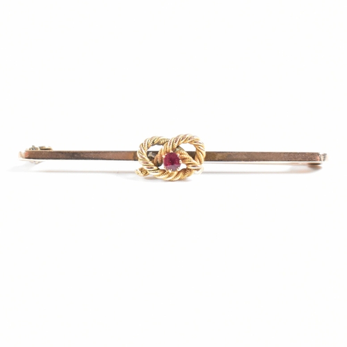 73 - A 1920s 9ct gold and ruby knot bar brooch pin. Marked 9ct. Weight 3.2g. Measures 5cm. All weights, m... 