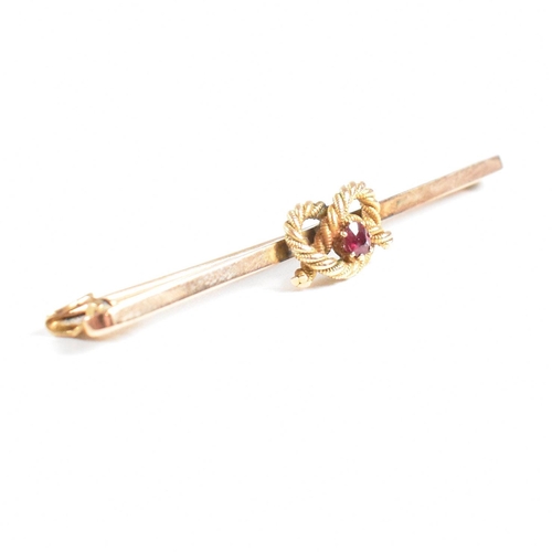 73 - A 1920s 9ct gold and ruby knot bar brooch pin. Marked 9ct. Weight 3.2g. Measures 5cm. All weights, m... 